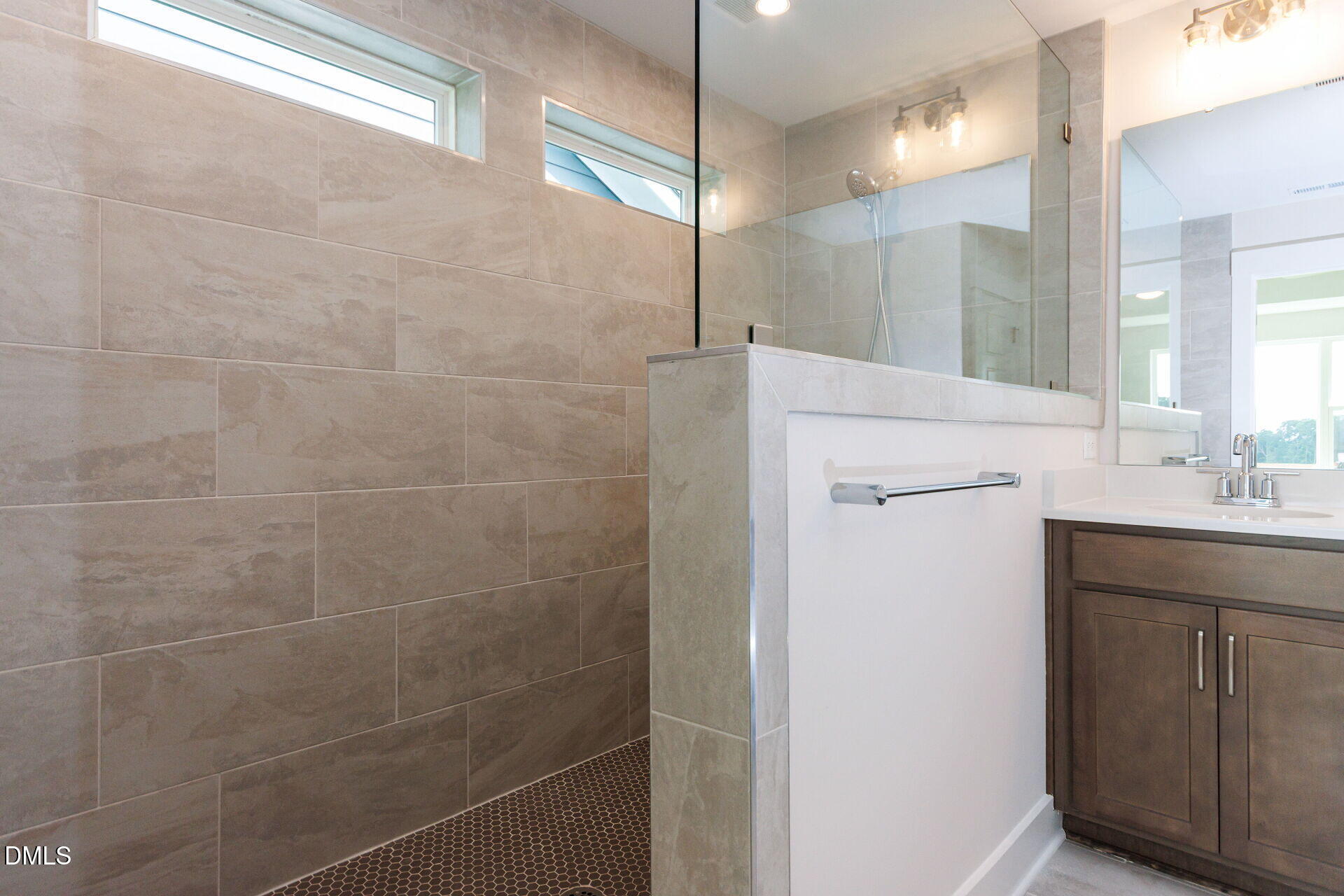 32 Relaxing Way Pittsboro, NC 27312 - Photo 19 of 32 a bathroom with a sink a mirror and a shower