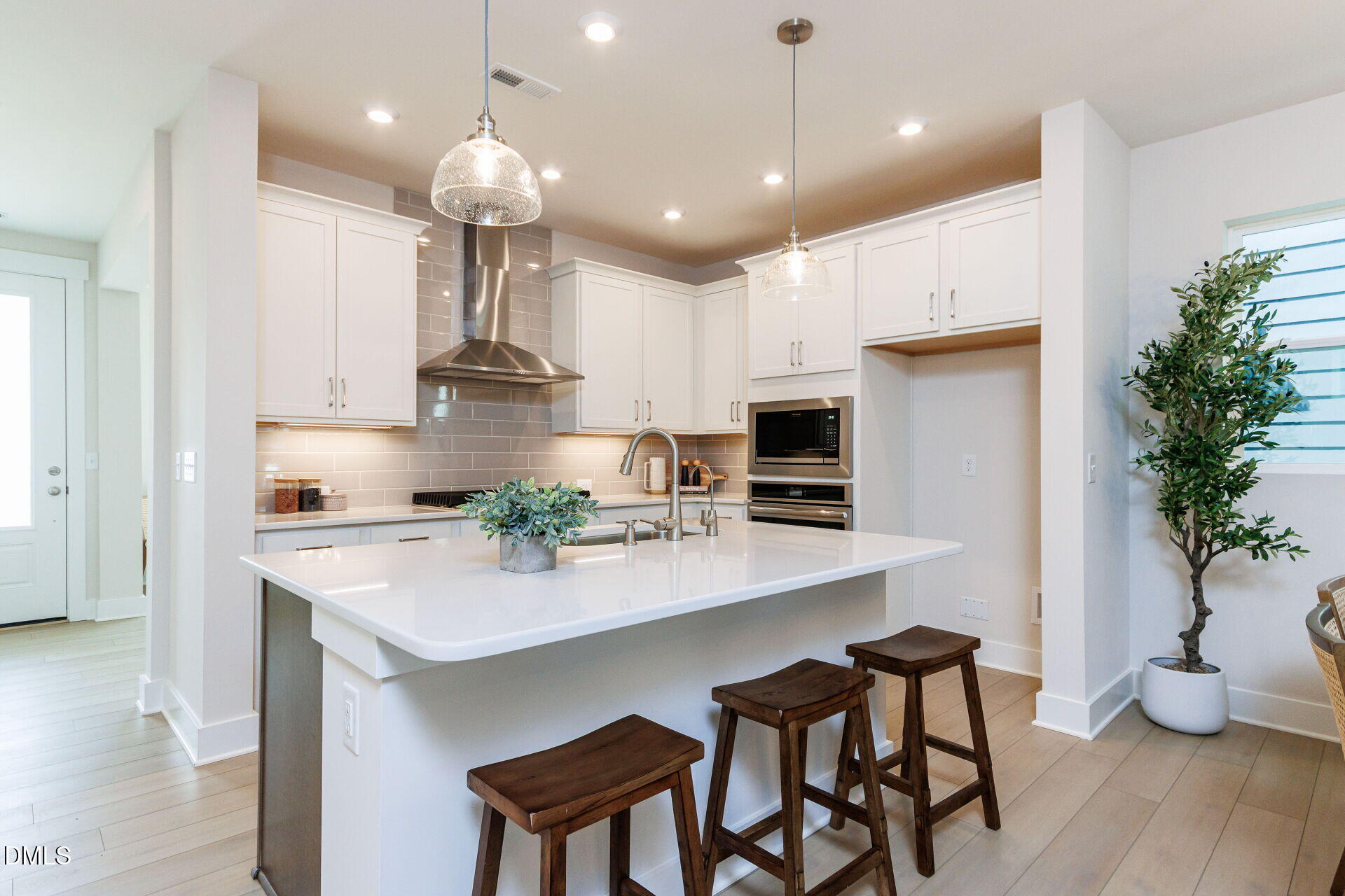 32 Relaxing Way Pittsboro, NC 27312 - Photo 8 of 32 a kitchen with kitchen island a stove a table and chairs in it