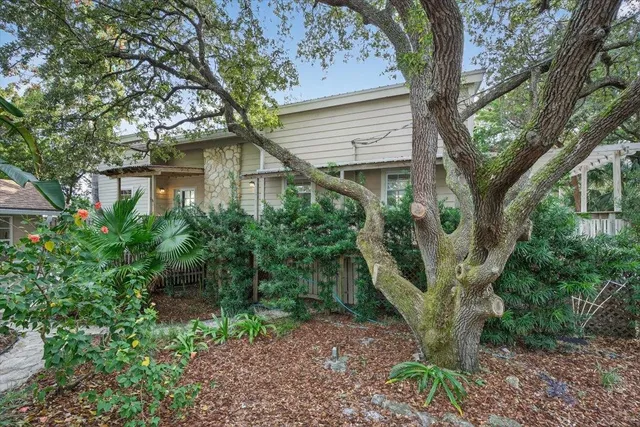 a living room with furniture fireplace and a large window