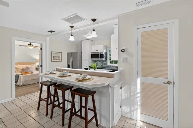a view of a yard with wooden fence and a large tree