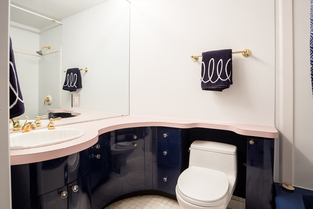 327 Commonwealth Avenue, Unit 2 Boston, MA 02115 - Photo 15 of 17 a bathroom with a toilet a sink and mirror