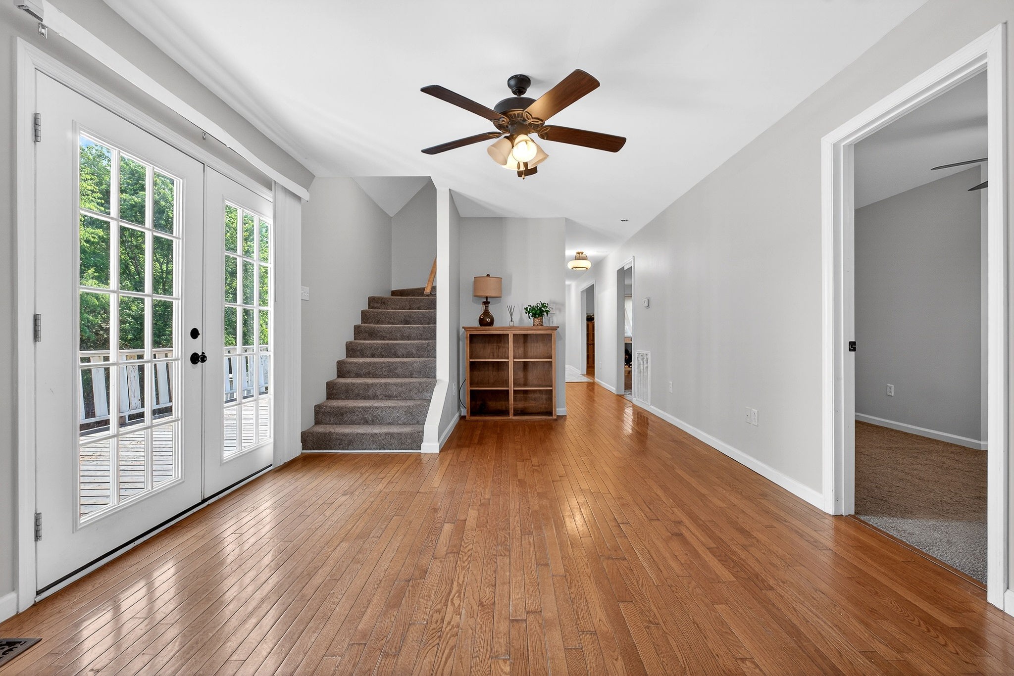 412 Rock Station Road Rock Island, TN 38581 - Photo 25 of 47 a view of a livingroom with wooden floor a ceiling fan and windows
