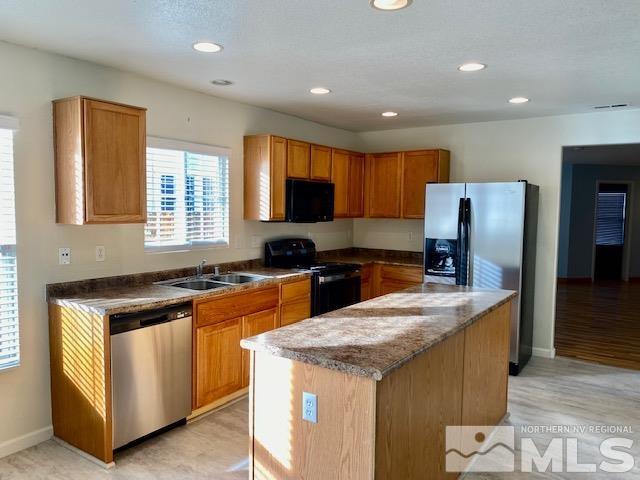 7622 Corso Street Reno, NV 89506 - Photo 5 of 19 a kitchen with granite countertop stainless steel appliances cabinets a sink and a counter top space