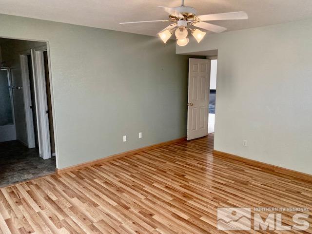 7622 Corso Street Reno, NV 89506 - Photo 8 of 19 a view of a room with a ceiling fan and wooden floor
