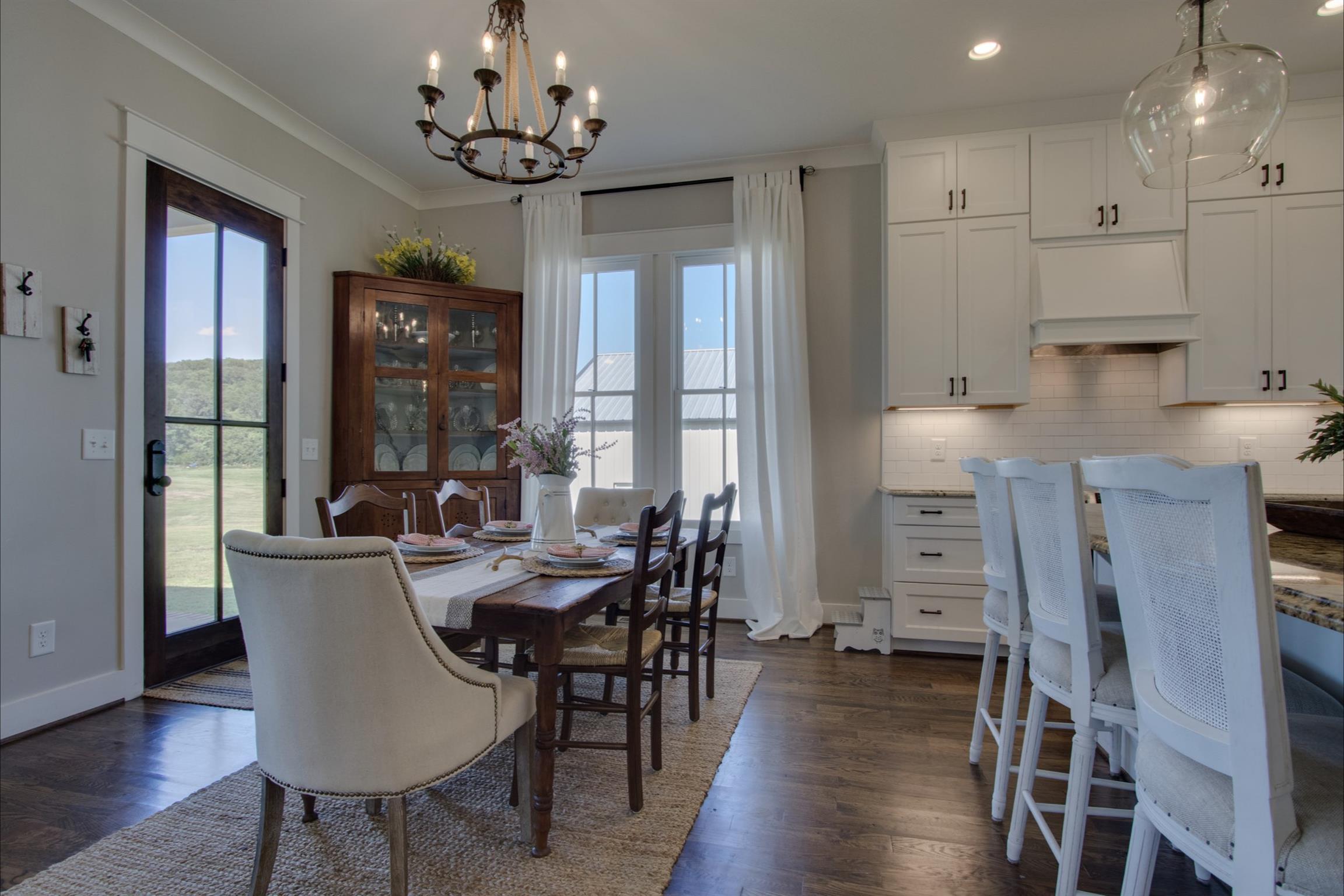 2845 Beech Log Road Watertown, TN 37184 - Photo 13 of 30 a dining room with furniture a chandelier and wooden floor
