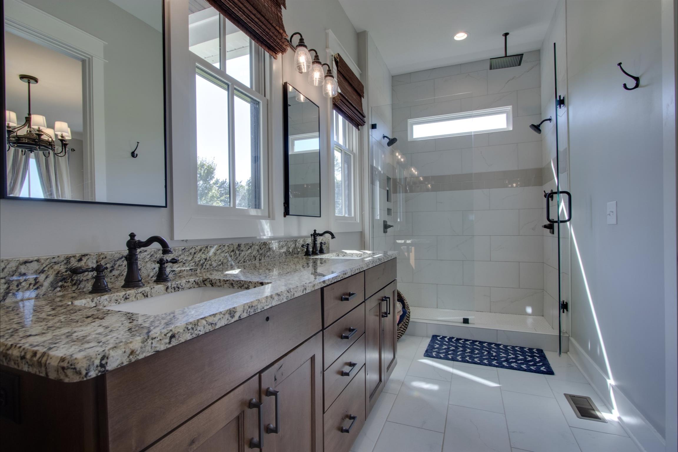2845 Beech Log Road Watertown, TN 37184 - Photo 18 of 30 a bathroom with a granite countertop sink a mirror and a shower