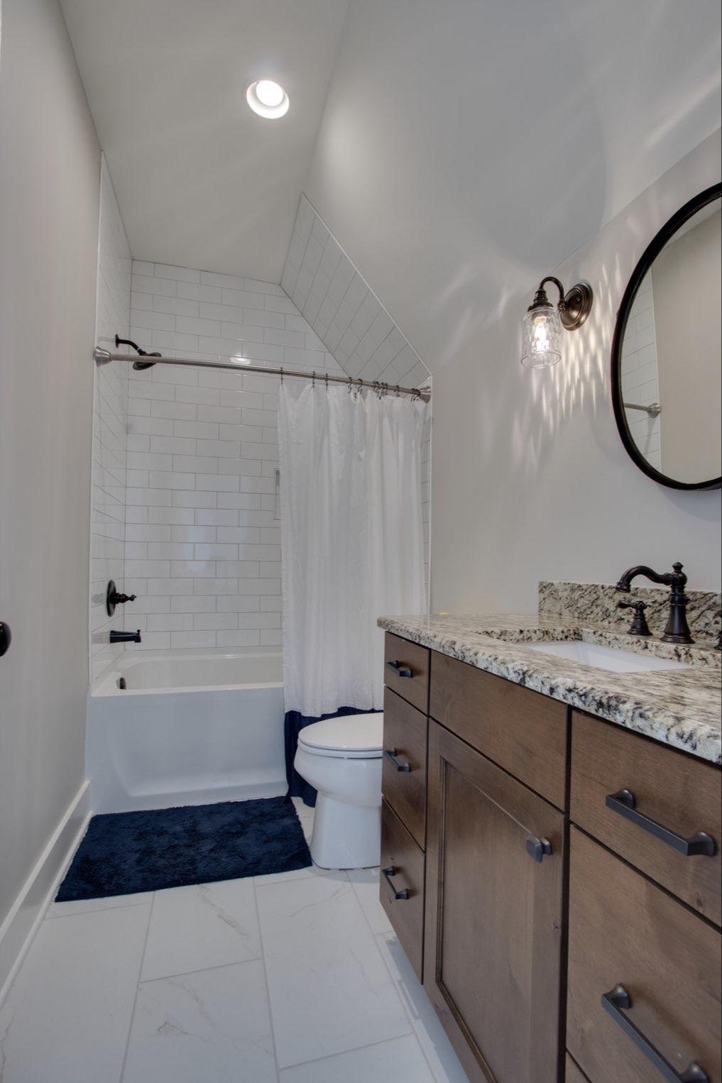 2845 Beech Log Road Watertown, TN 37184 - Photo 20 of 30 a bathroom with a granite countertop sink a toilet and bathtub