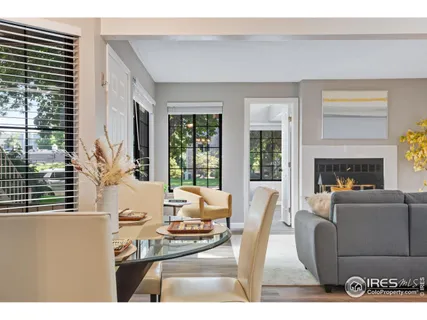 a living room with furniture a large window and a fireplace