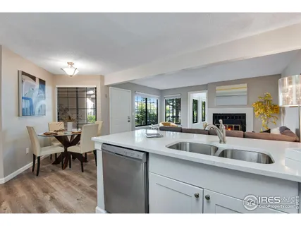 a kitchen with a sink and living room