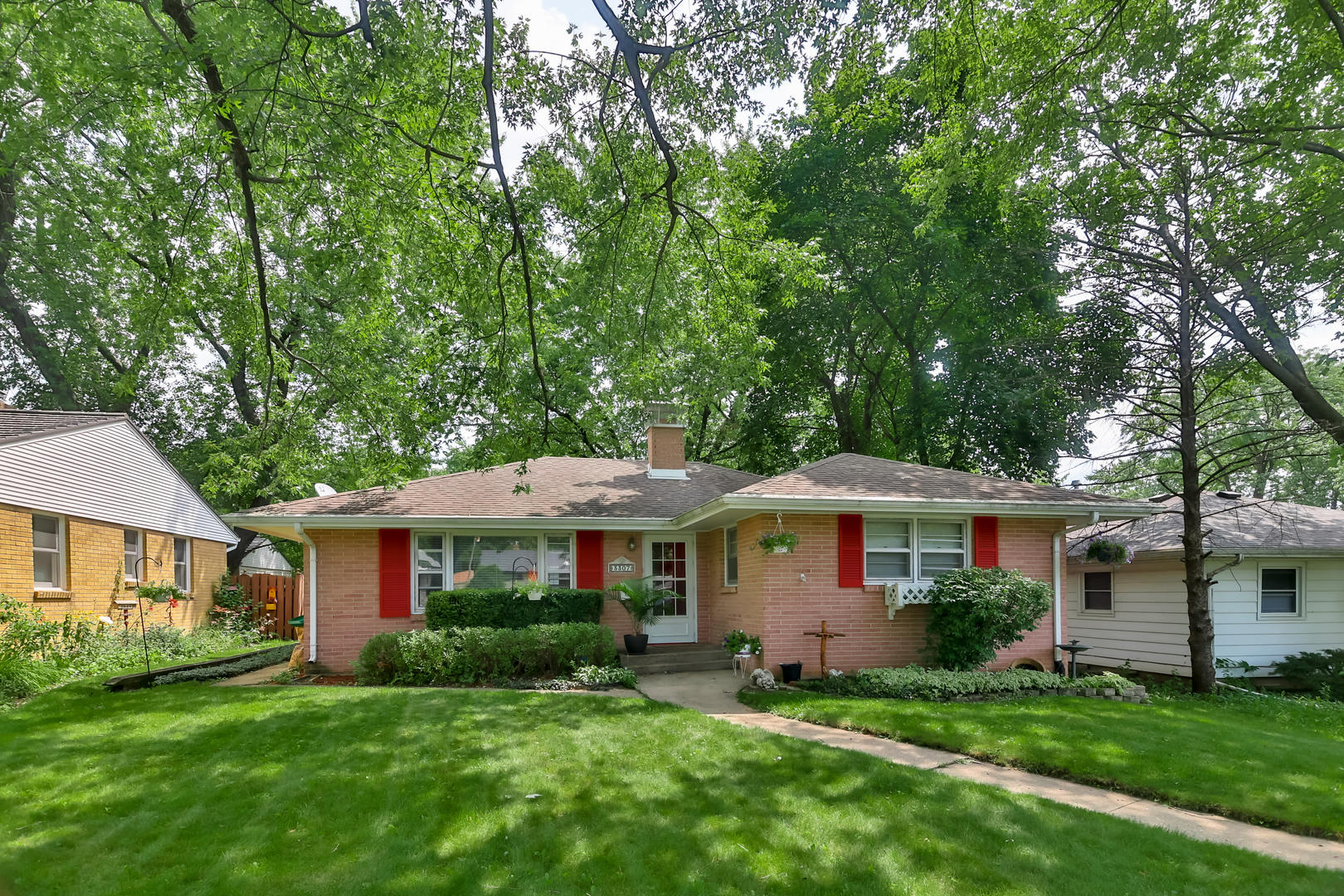 a front view of a house with a garden