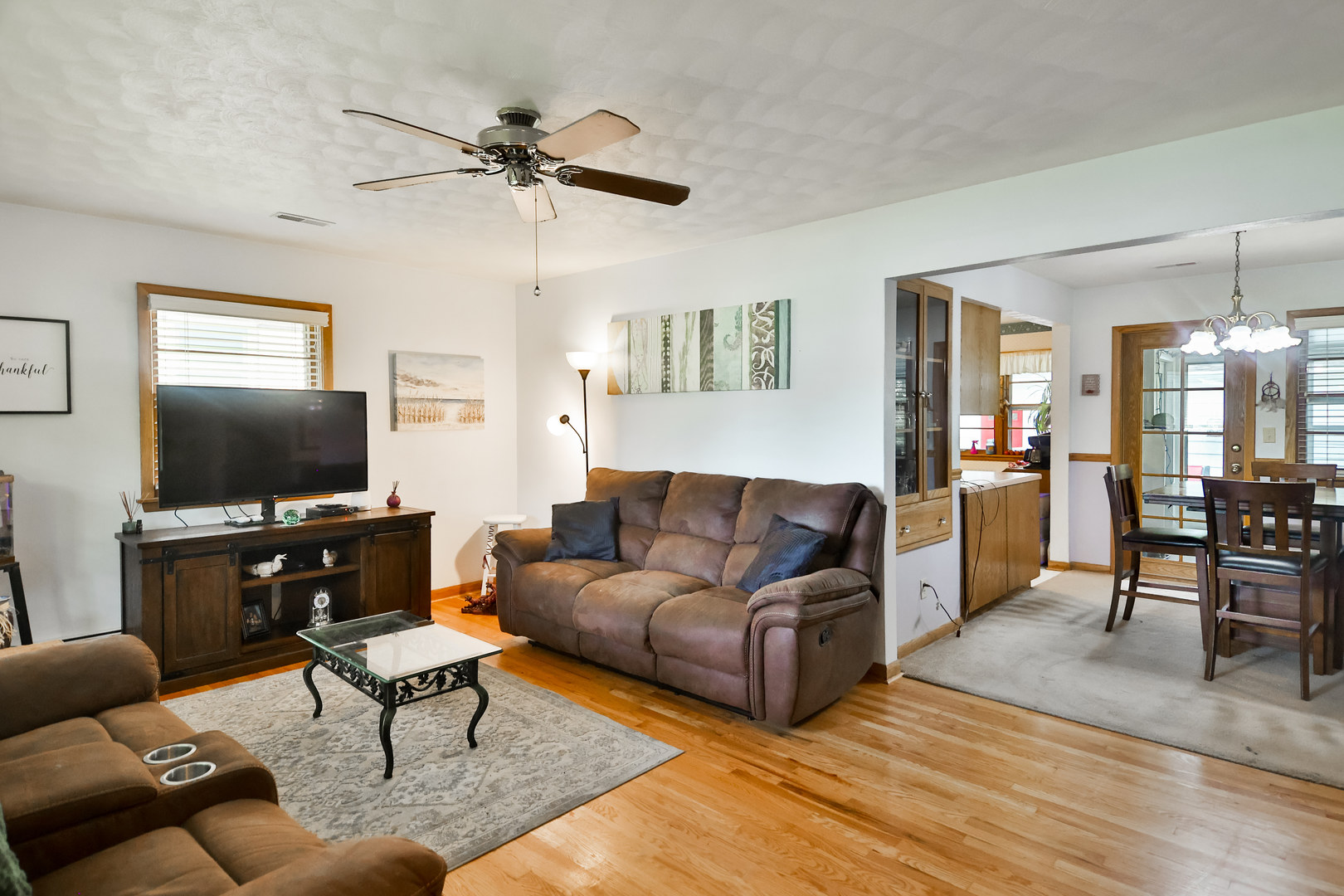 3307 Ruth Street Rockford, IL 61103 - Photo 3 of 28 a living room with furniture a flat screen tv and a table