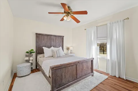 a bedroom with a bed and a ceiling fan