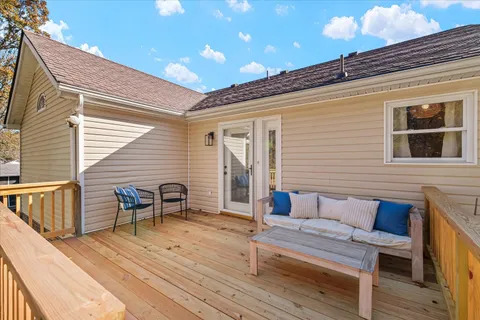 a balcony with furniture and wooden floor