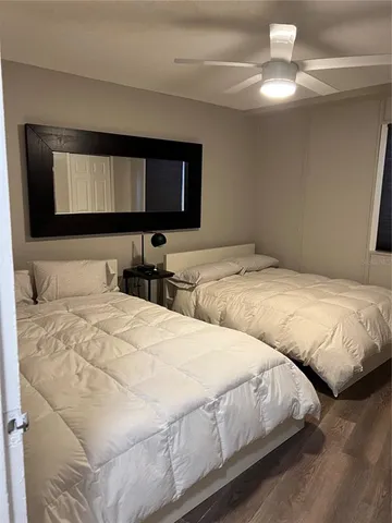 a bedroom with double bed and a chandelier