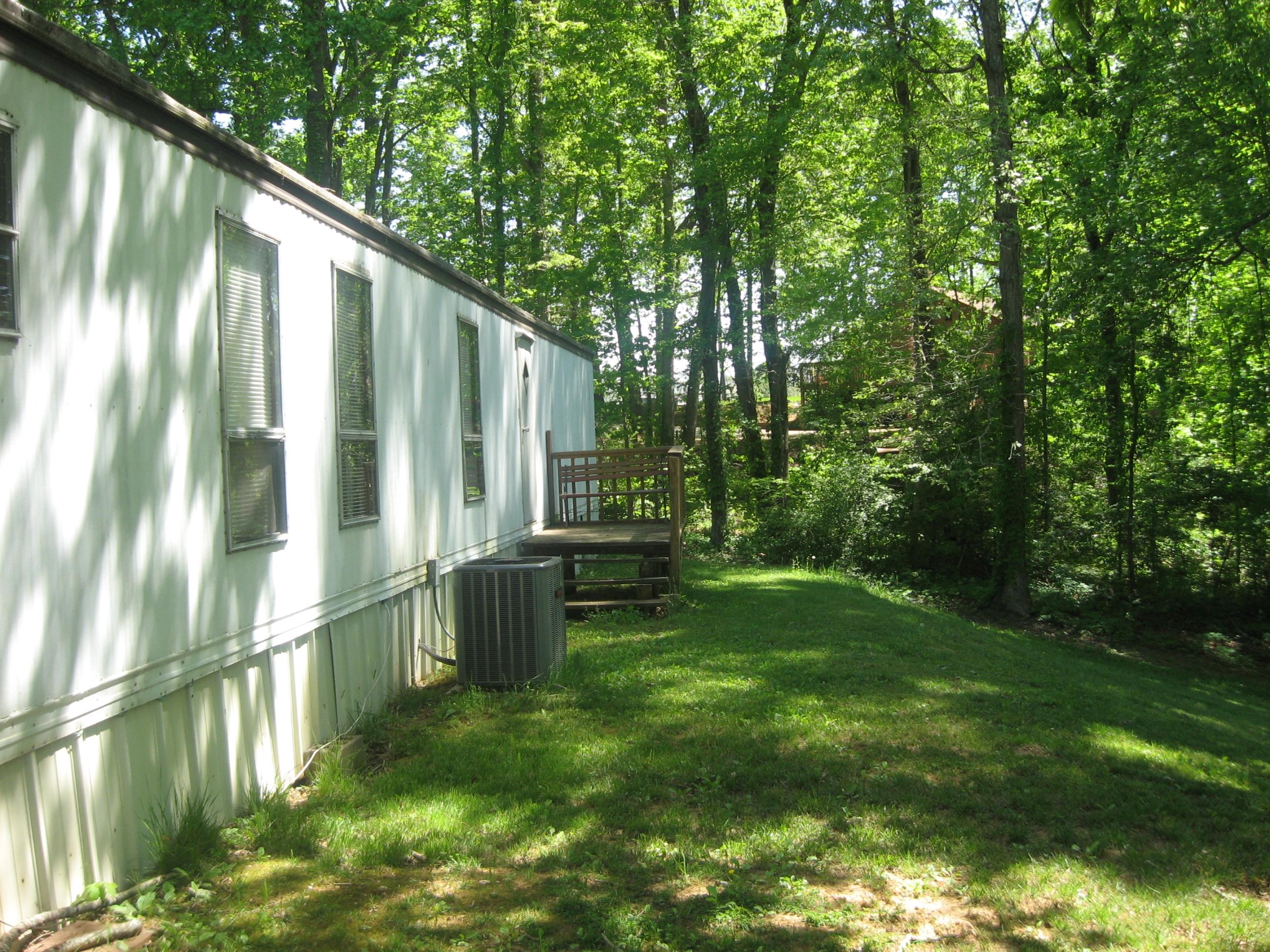 2089 Morgans Mill Road Goodview, VA 24095 - Photo 4 of 9 a backyard of a house with a garden and plants