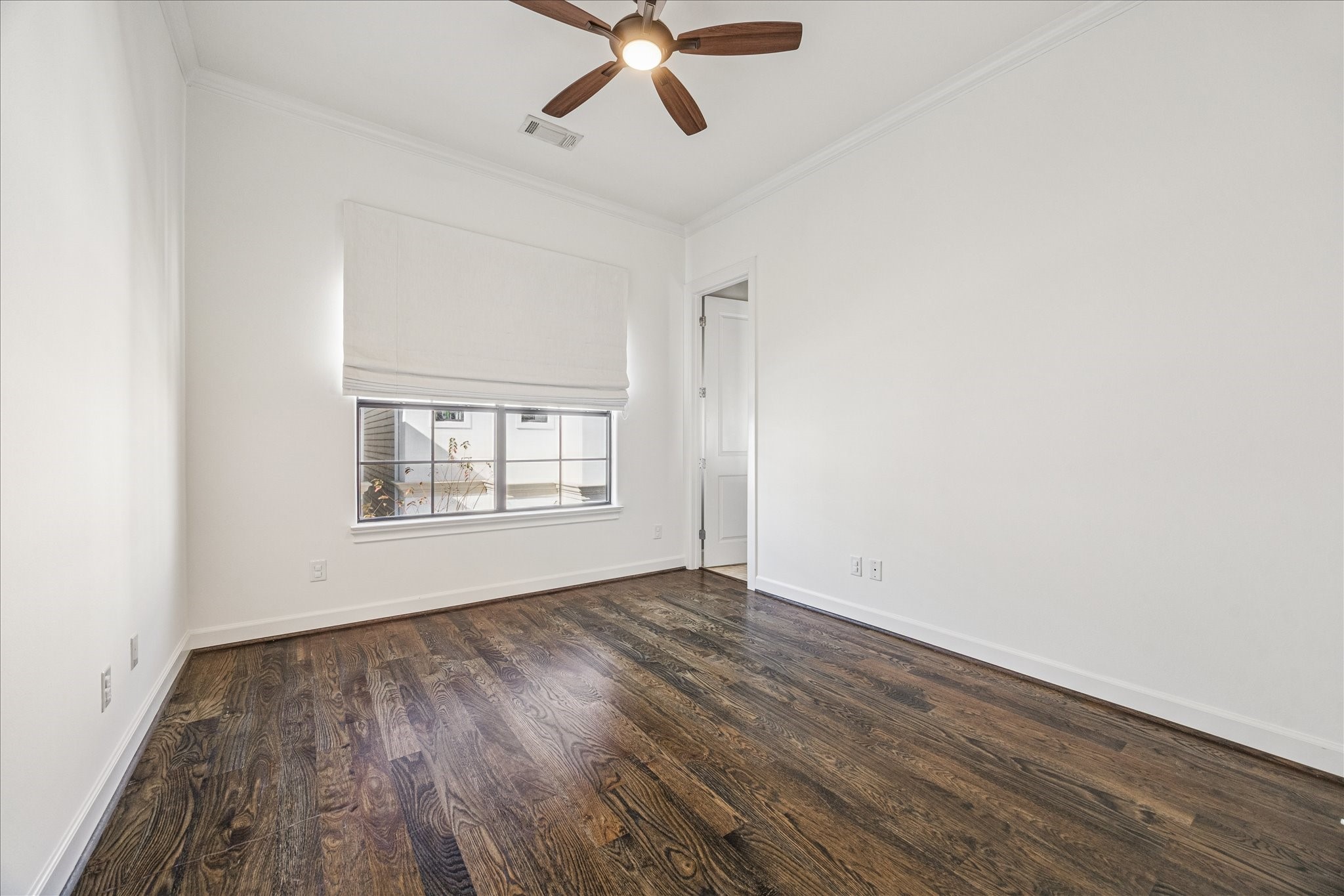 2210 Converse Street Houston, TX 77006 - Photo 23 of 35 an empty room with wooden floor fan and windows
