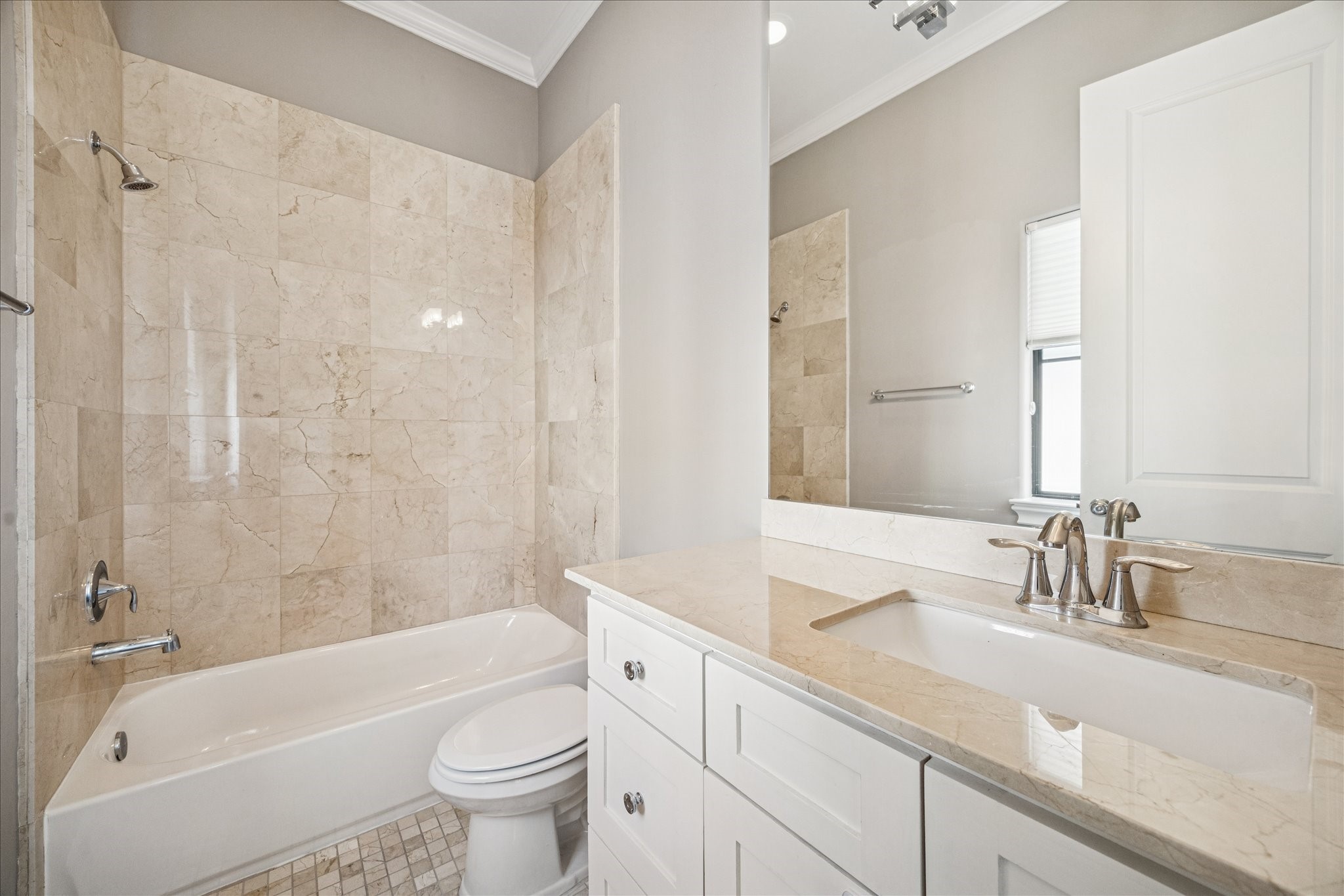 2210 Converse Street Houston, TX 77006 - Photo 24 of 35 a bathroom with a sink a toilet a mirror a bathtub and shower