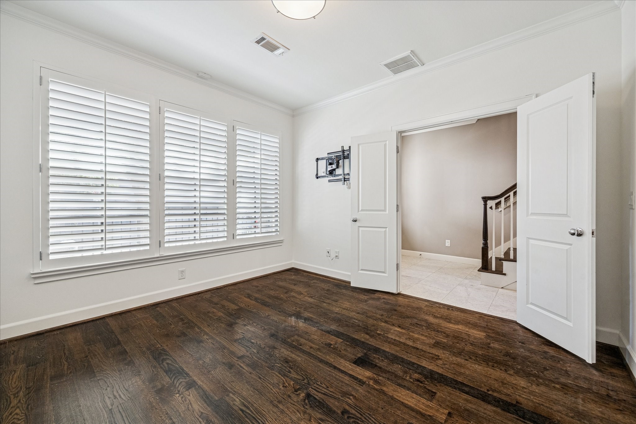 2210 Converse Street Houston, TX 77006 - Photo 7 of 35 an empty room with wooden floor and windows