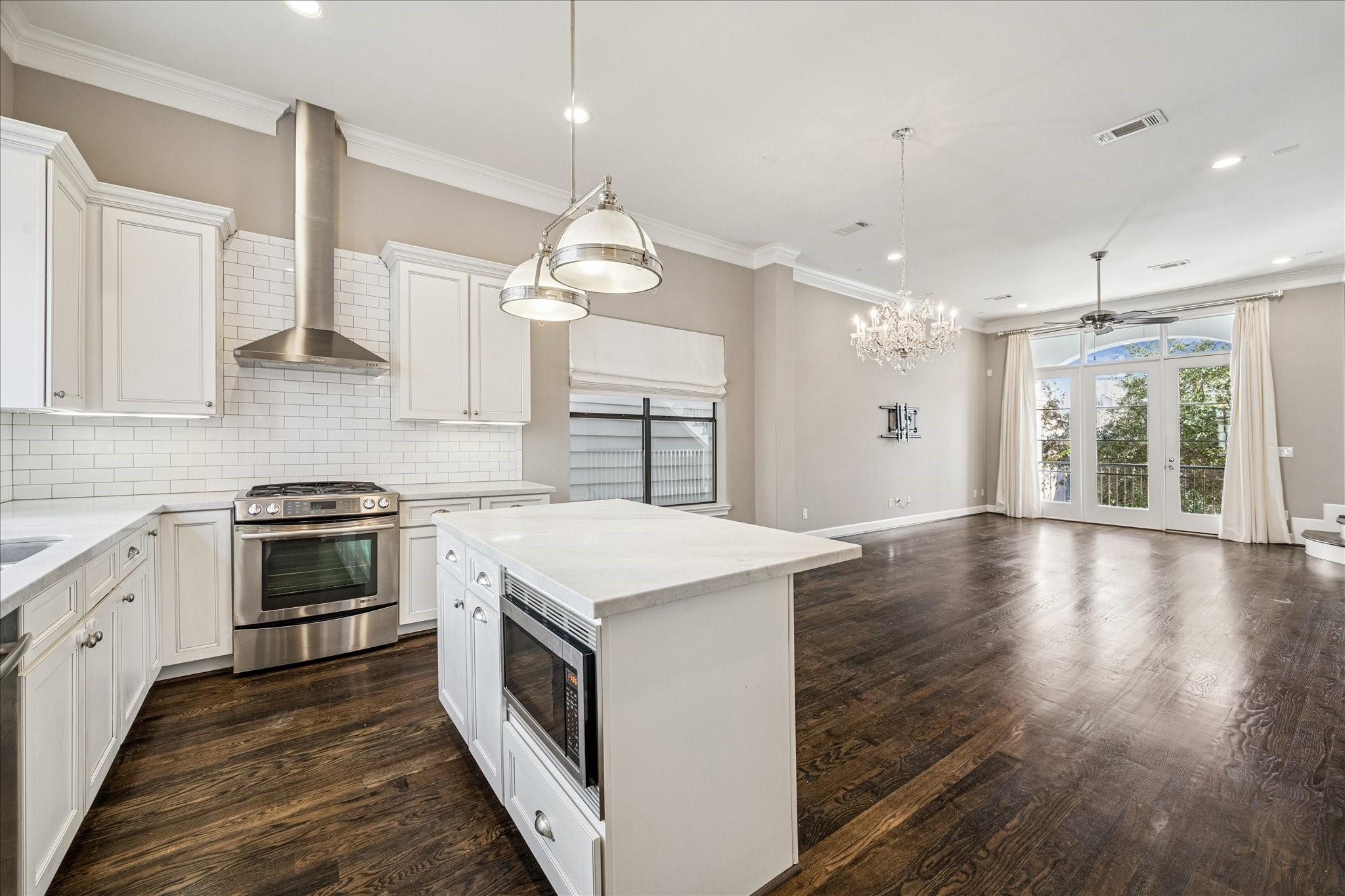 2210 Converse Street Houston, TX 77006 - Photo 8 of 35 a large kitchen with stainless steel appliances granite countertop a stove and a wooden floors