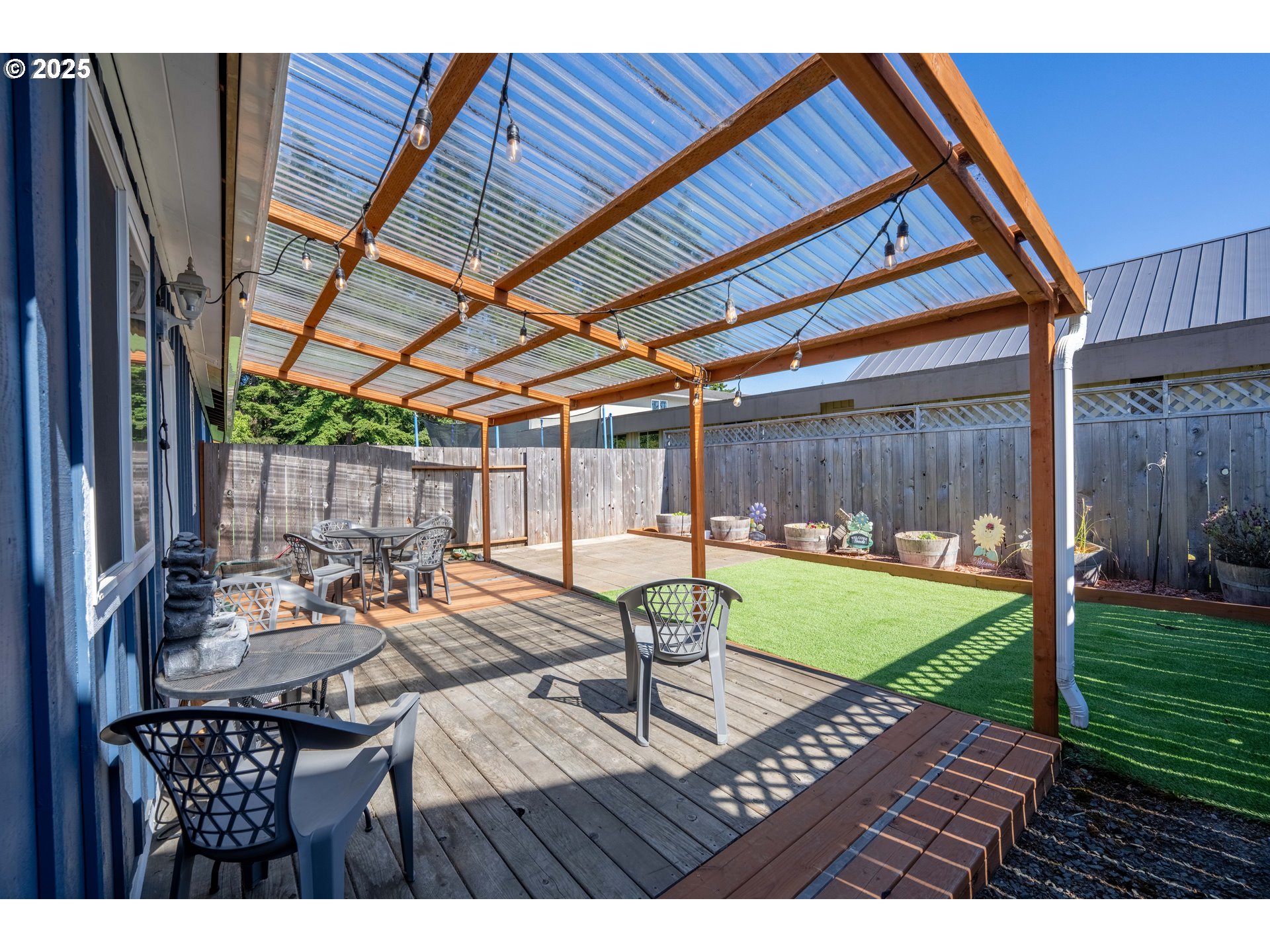 1935 17th Street North Bend, OR 97459 - Photo 39 of 44 a view of a patio with table and chairs with wooden floor and fence