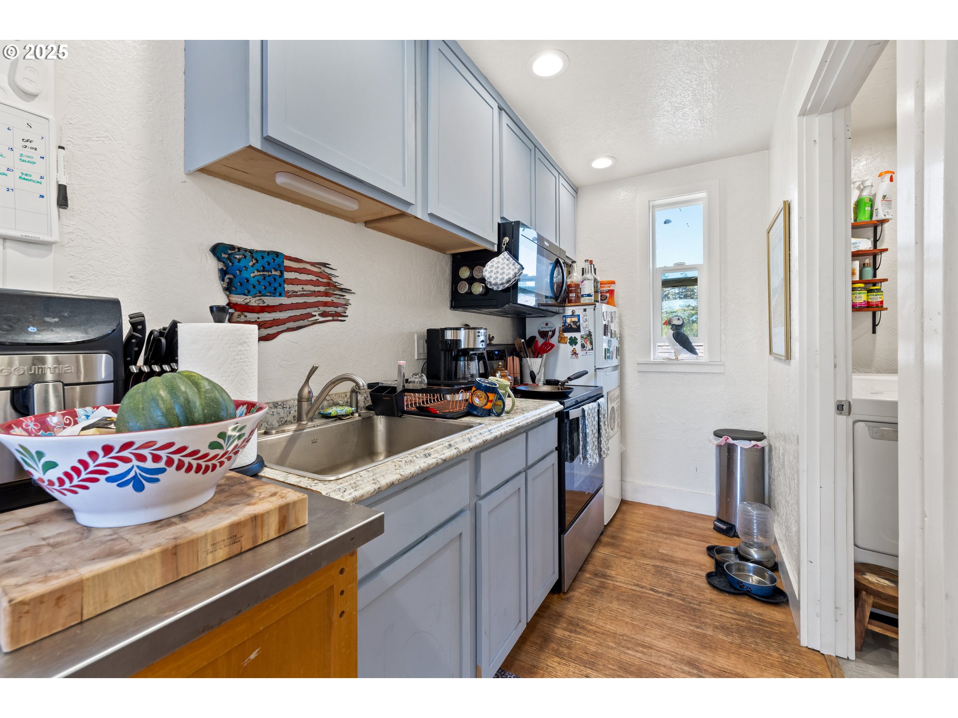 1935 17th Street North Bend, OR 97459 - Photo 43 of 44 a kitchen view of counter top space a sink a refrigerator and a cabinets