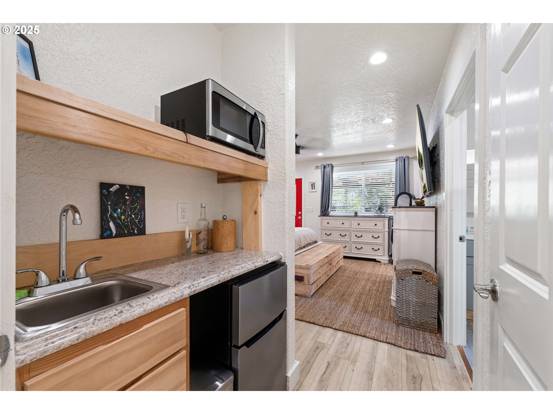 1935 17th Street North Bend, OR 97459 - Photo 7 of 44 a kitchen with stainless steel appliances kitchen island granite countertop a sink and cabinets