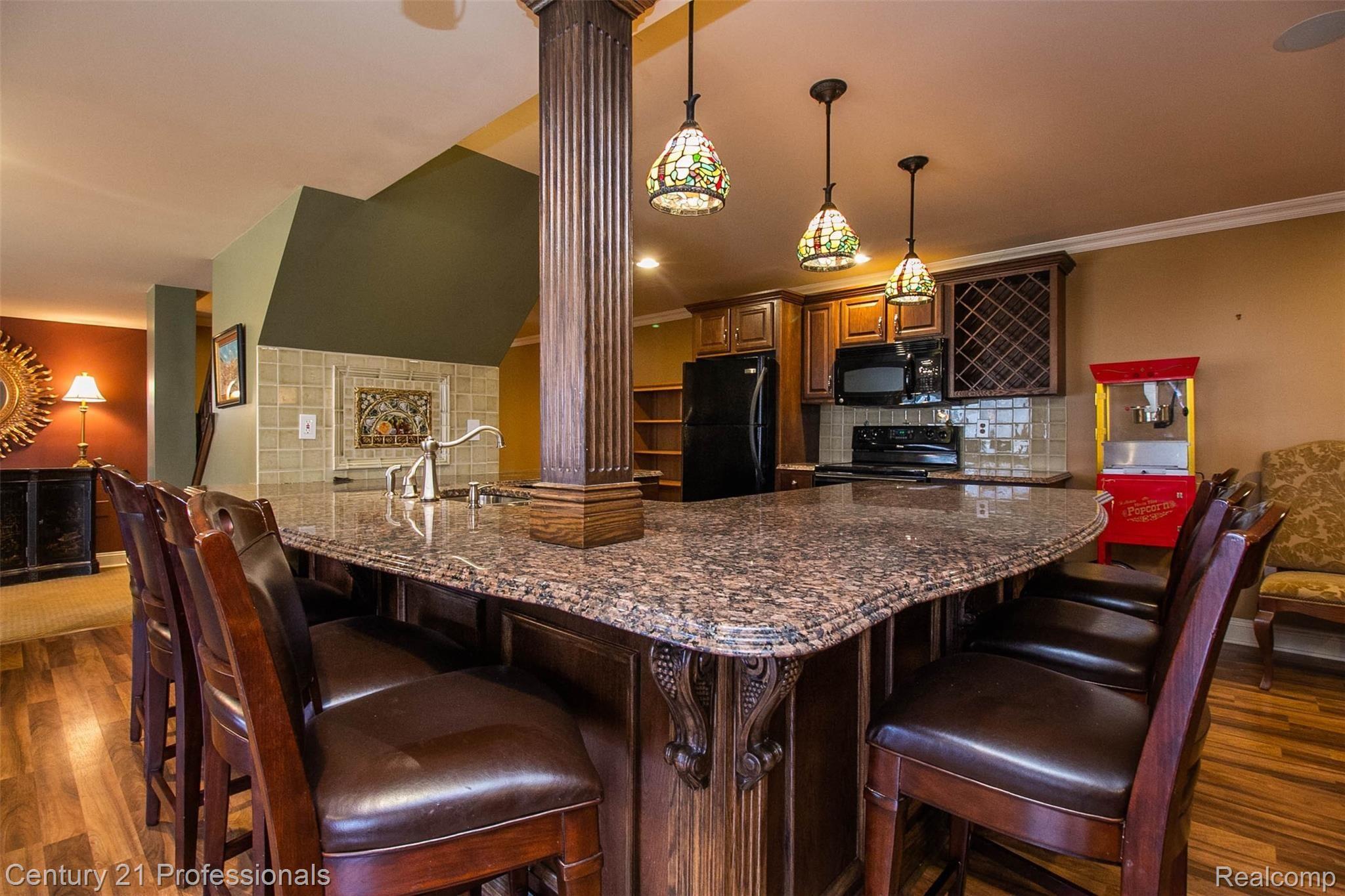 69401 Eldred Road Romeo, MI 48065 - Photo 47 of 65 Full Kitchen w/ cer tile backsplash, granite counters and wood cabinets