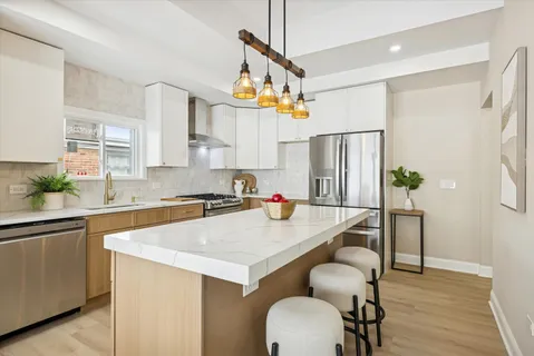 a kitchen with sink cabinets and wooden floor
