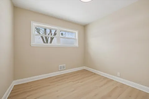 a view of a room with wooden floor and wall painting
