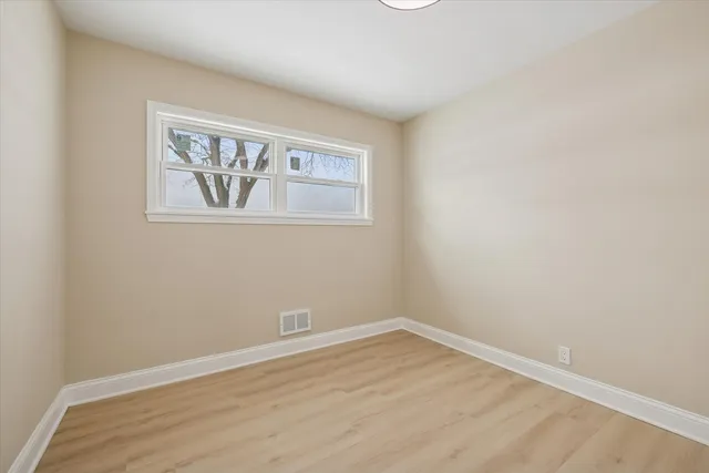 a view of a room with wooden floor and wall painting