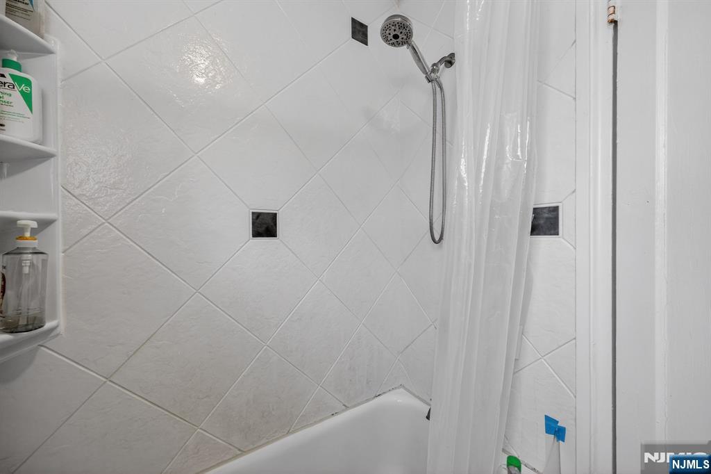243 Johnson Avenue, Unit L4 Hackensack, NJ 07601 - Photo 18 of 25 a bathroom with a shower