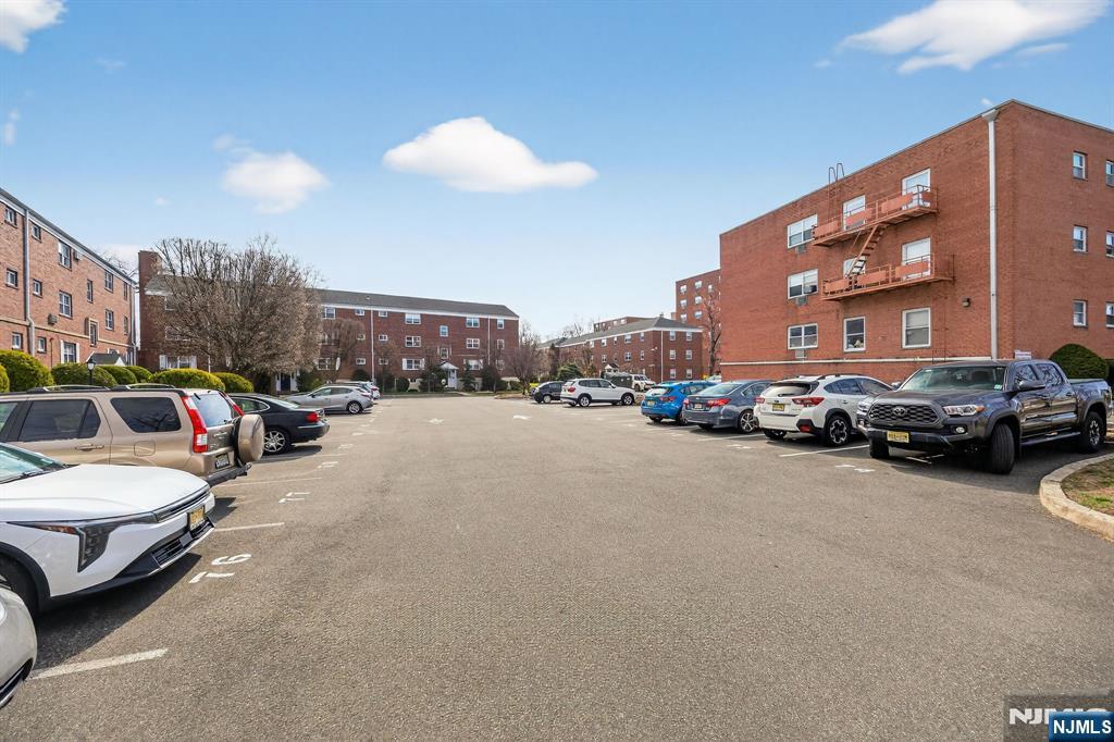 243 Johnson Avenue, Unit L4 Hackensack, NJ 07601 - Photo 25 of 25 a view of a cars park in front of a building