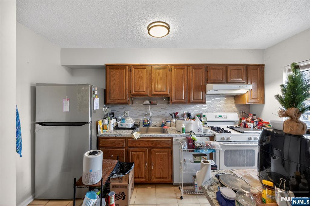 243 Johnson Avenue, Unit L4 Hackensack, NJ 07601 - Photo 3 of 25 a room with a cabinets and a couch