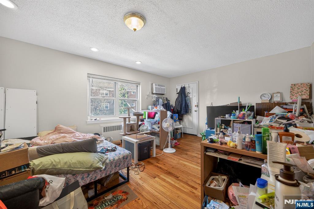 243 Johnson Avenue, Unit L4 Hackensack, NJ 07601 - Photo 8 of 25 a living room with lots of furniture and a wooden floor