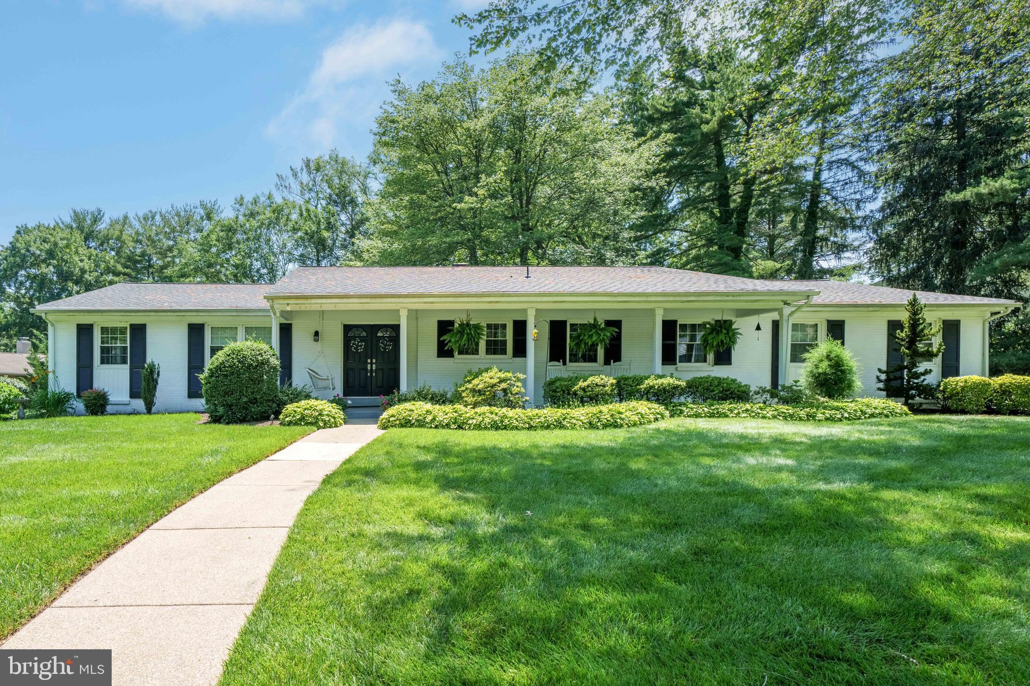 4614 Sylvanus Drive Wilmington, DE 19803 - Photo 1 of 48 a front view of a house with a yard table and chairs
