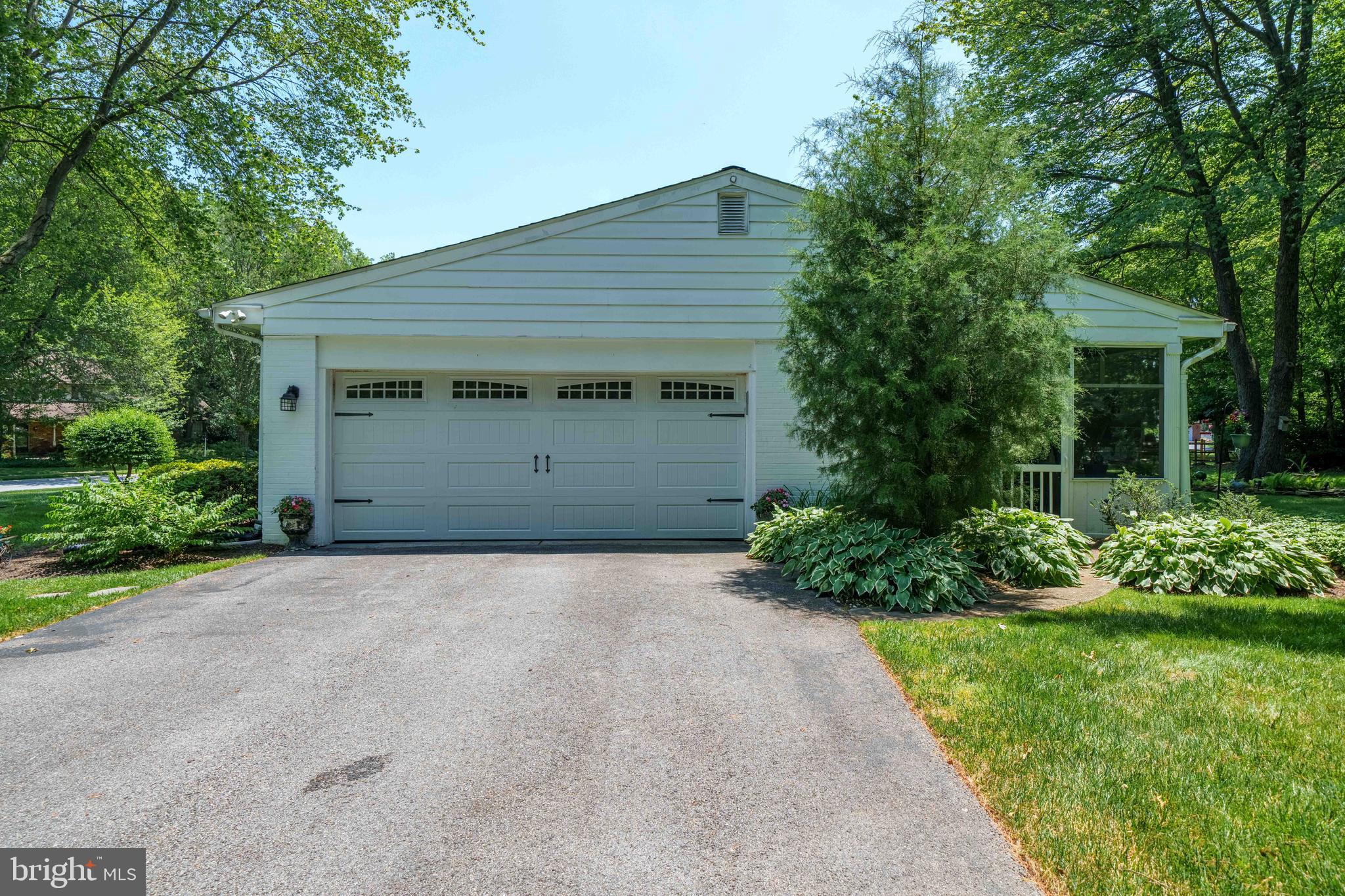 4614 Sylvanus Drive Wilmington, DE 19803 - Photo 10 of 48 a front view of a house with a yard and garage