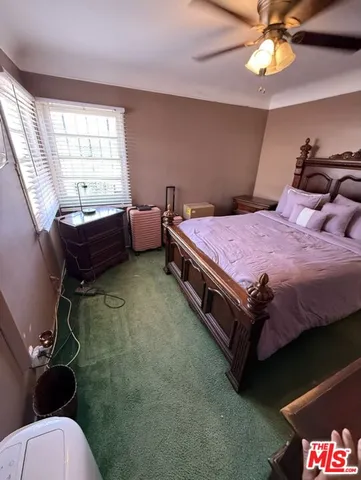 a spacious bedroom with a bed and a chandelier