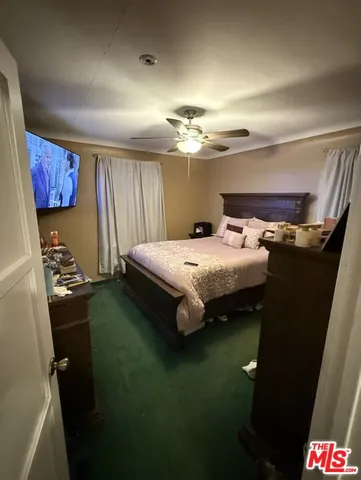 a bedroom with a bed and a lamp