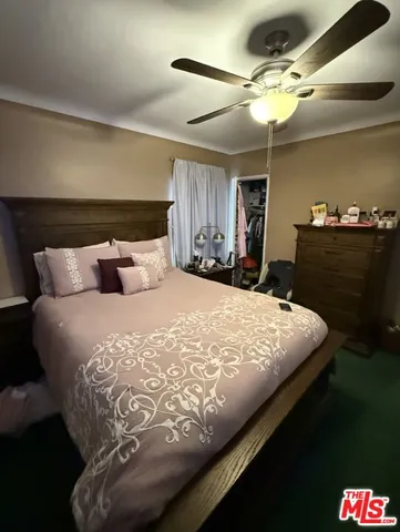 a bedroom with a bed and dresser