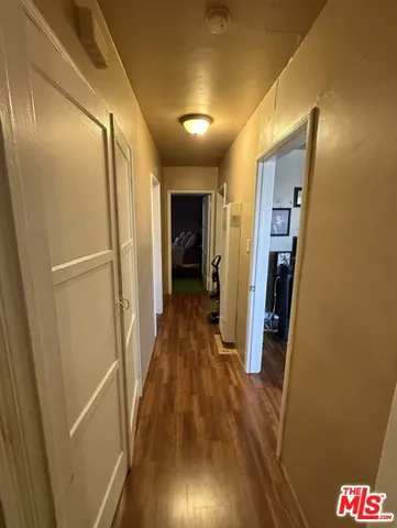 a view of hallway with wooden floor