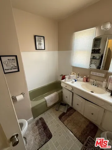 a bathroom with a double vanity sink mirror and toilet
