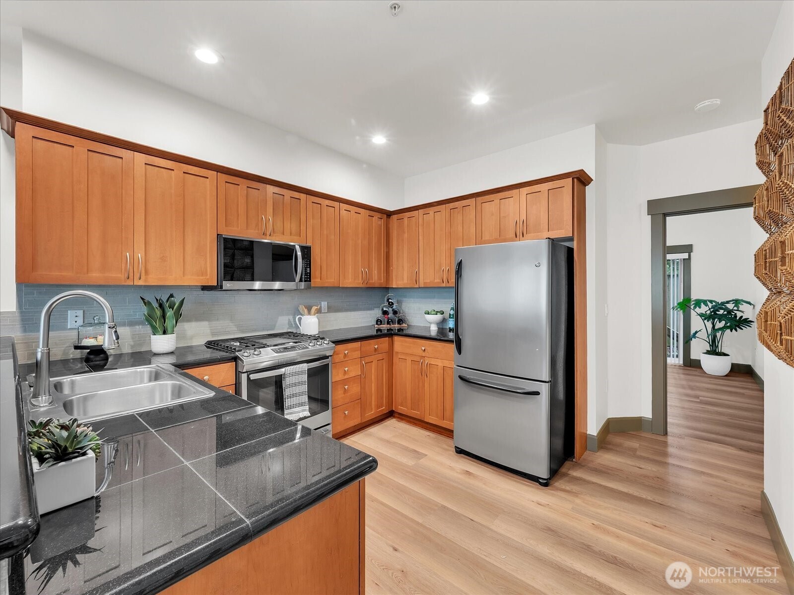 2115 201st Place Southeast, Unit K2 Bothell, WA 98012 - Photo 9 of 28 a kitchen with stainless steel appliances granite countertop a refrigerator stove microwave and sink