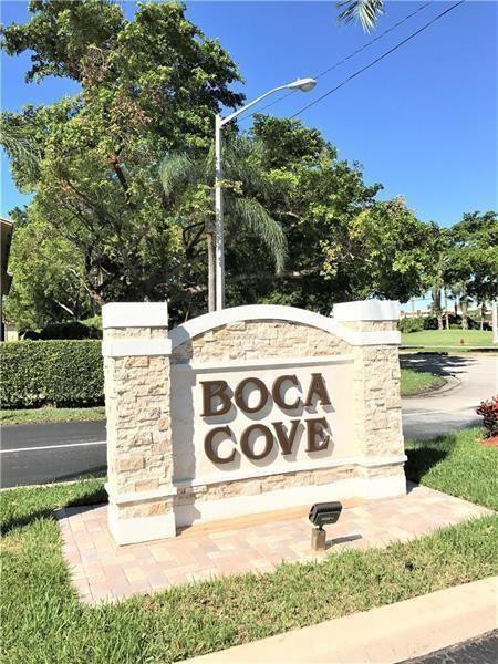 9449 Boca Cove Circle, Unit 908 Boca Raton, FL 33428 - Photo 1 of 12 a view of a street with benches and a small yard