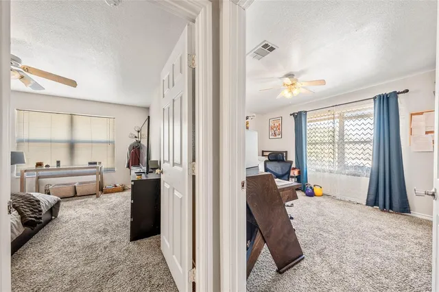 a bedroom with furniture and a large window