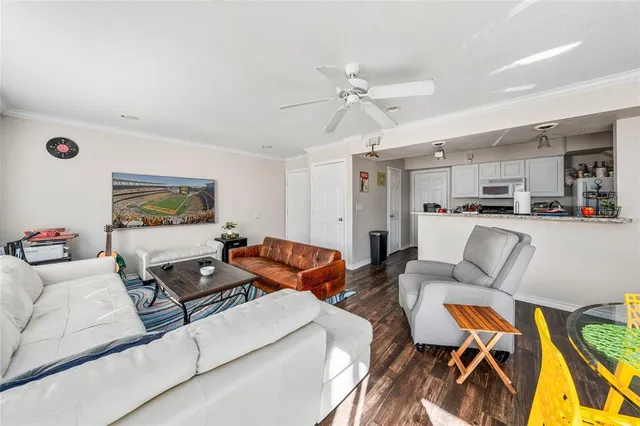 a living room with furniture and a view of kitchen