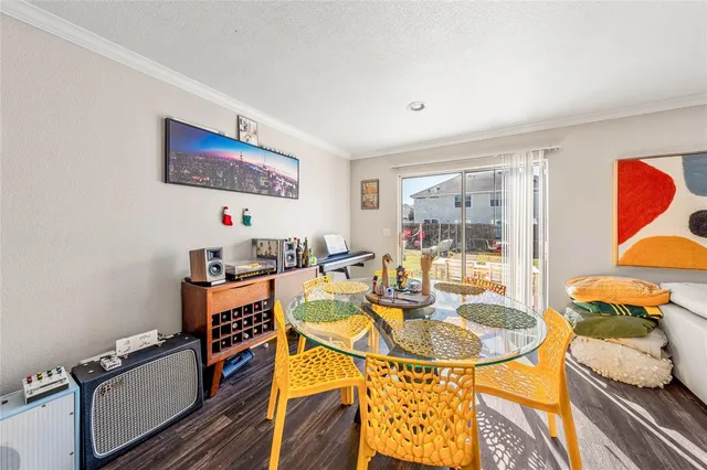 a dining room with furniture and wooden floor