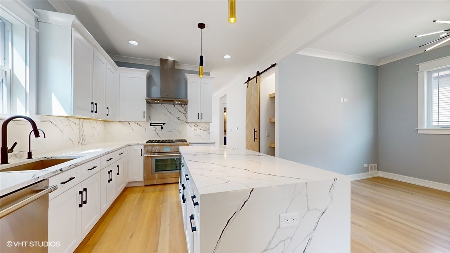 4115 North Ridgeway Avenue Chicago, IL 60618 - Photo 11 of 46 a kitchen with stainless steel appliances granite countertop a sink stove and refrigerator