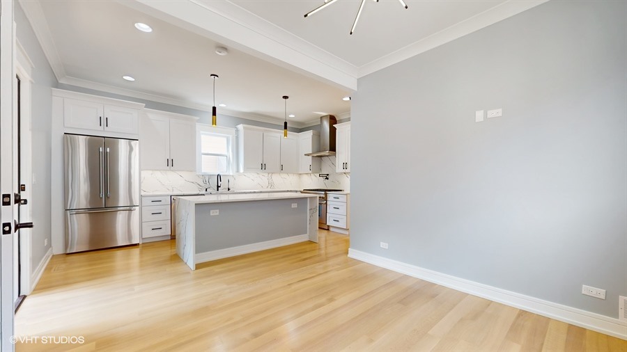 4115 North Ridgeway Avenue Chicago, IL 60618 - Photo 12 of 46 a kitchen with a refrigerator and white cabinets