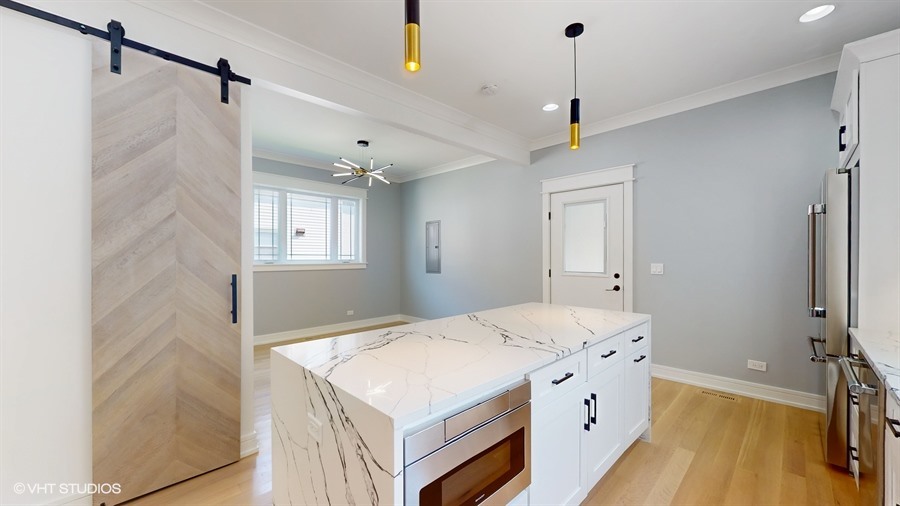 4115 North Ridgeway Avenue Chicago, IL 60618 - Photo 13 of 46 a bathroom with a sink a vanity and a mirror