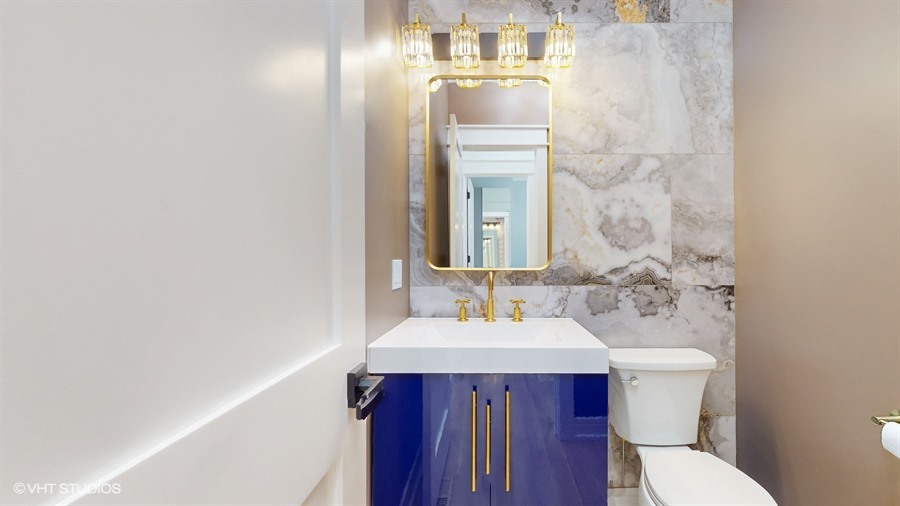 4115 North Ridgeway Avenue Chicago, IL 60618 - Photo 15 of 46 a bathroom with a sink a toilet and mirror